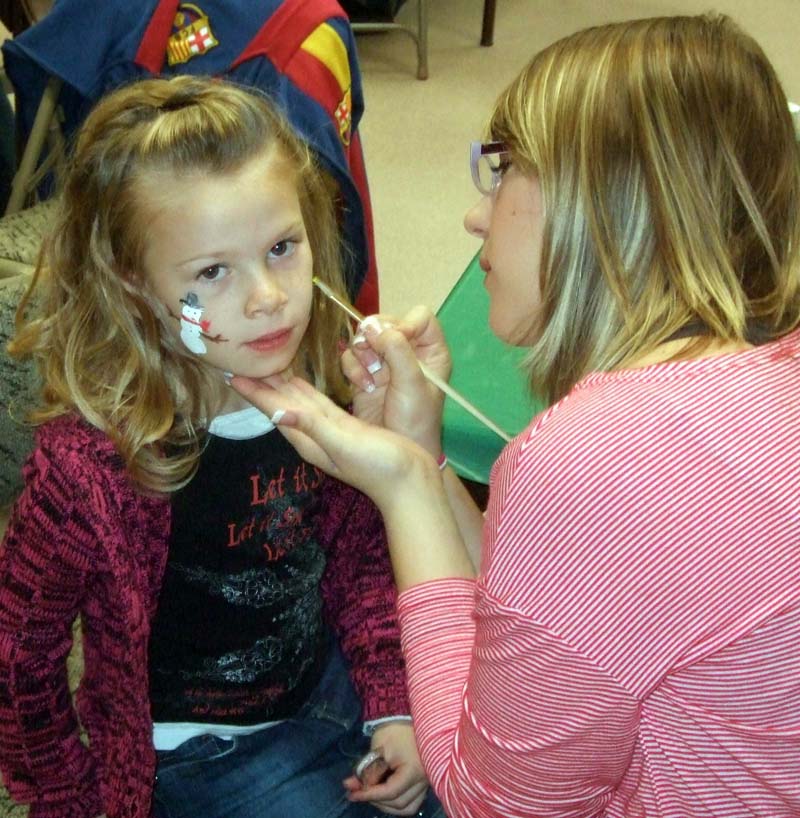photo of girl getting face painted